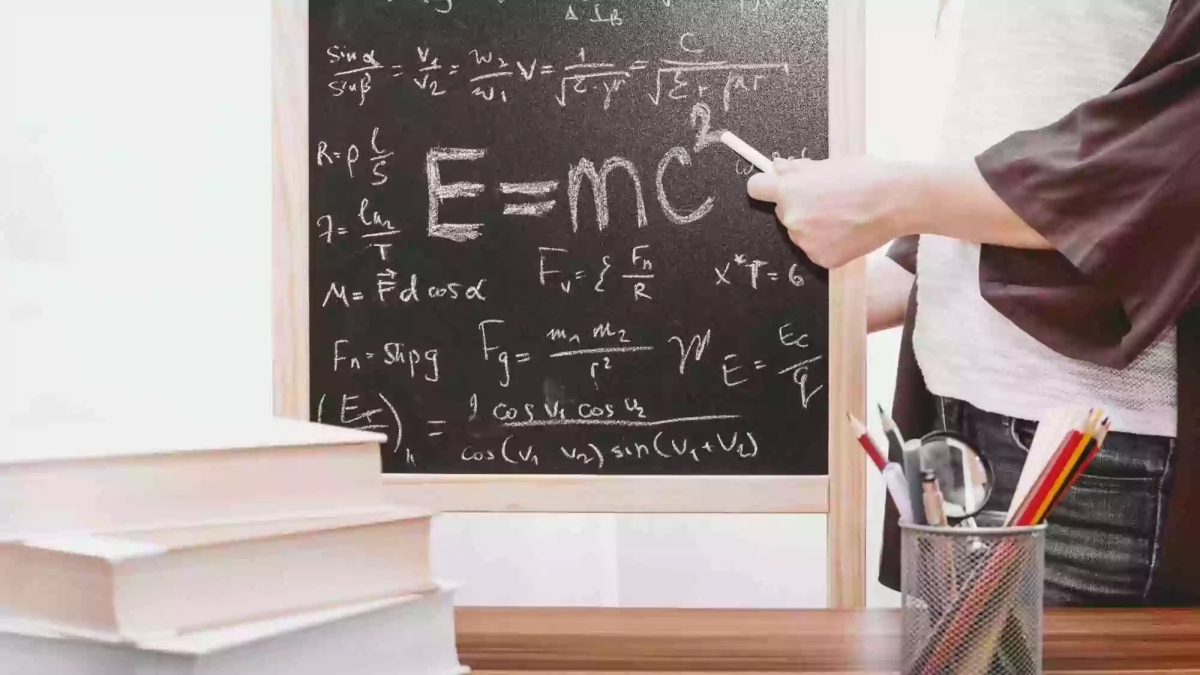 Picture of teacher at blackboard with e=mc2